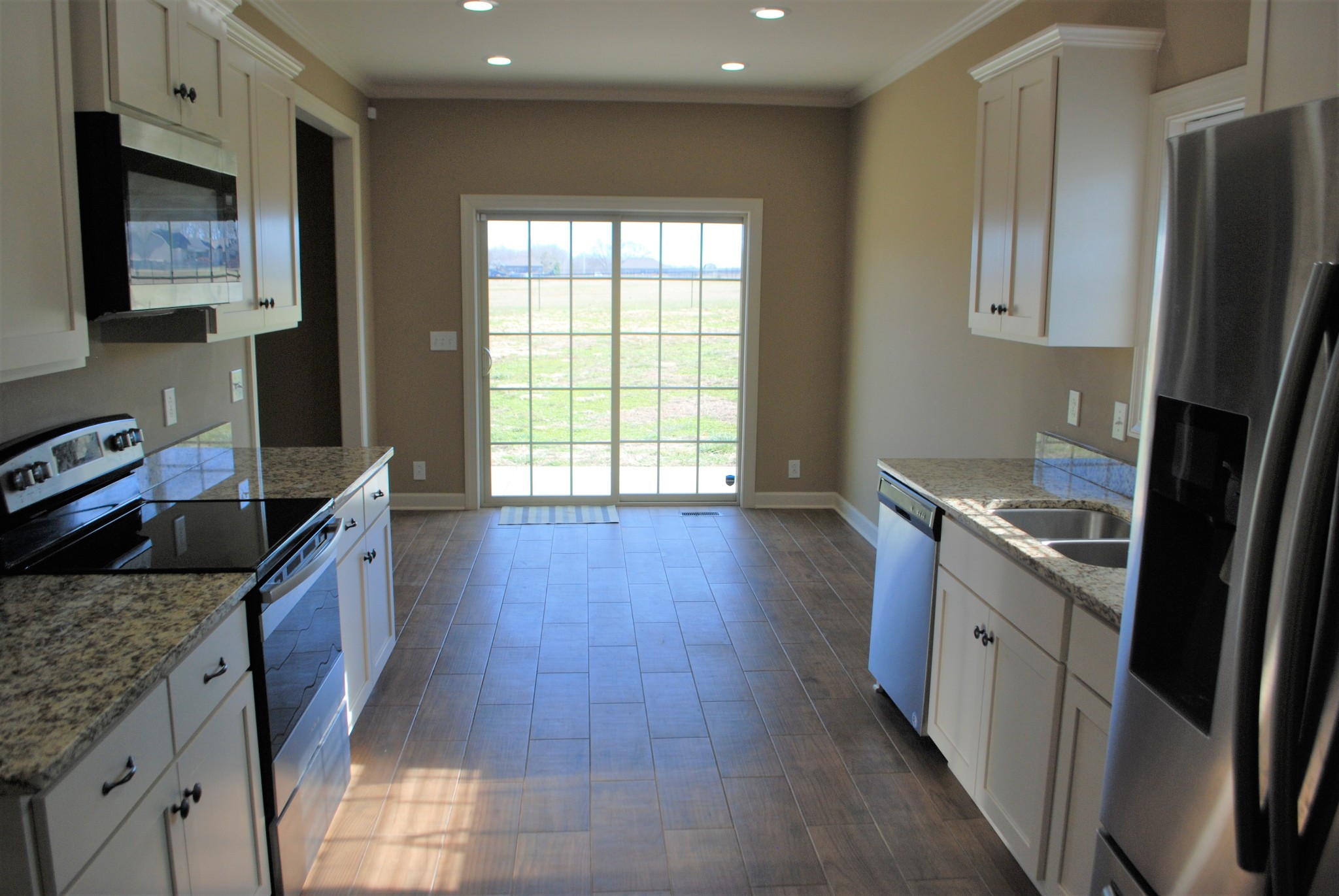 82 Diamond Road Manchester, TN 37355 - Photo 5 of 18 a kitchen with stainless steel appliances granite countertop a stove a sink and a refrigerator