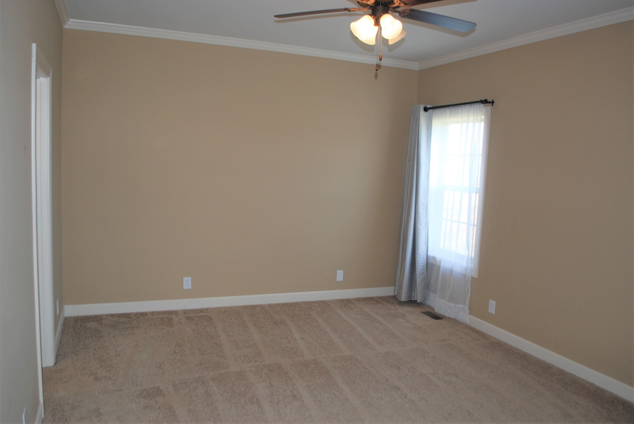 82 Diamond Road Manchester, TN 37355 - Photo 6 of 18 an empty room with a chandelier fan and windows