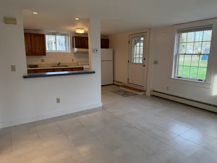 a living room with kitchen island granite countertop furniture and a fireplace