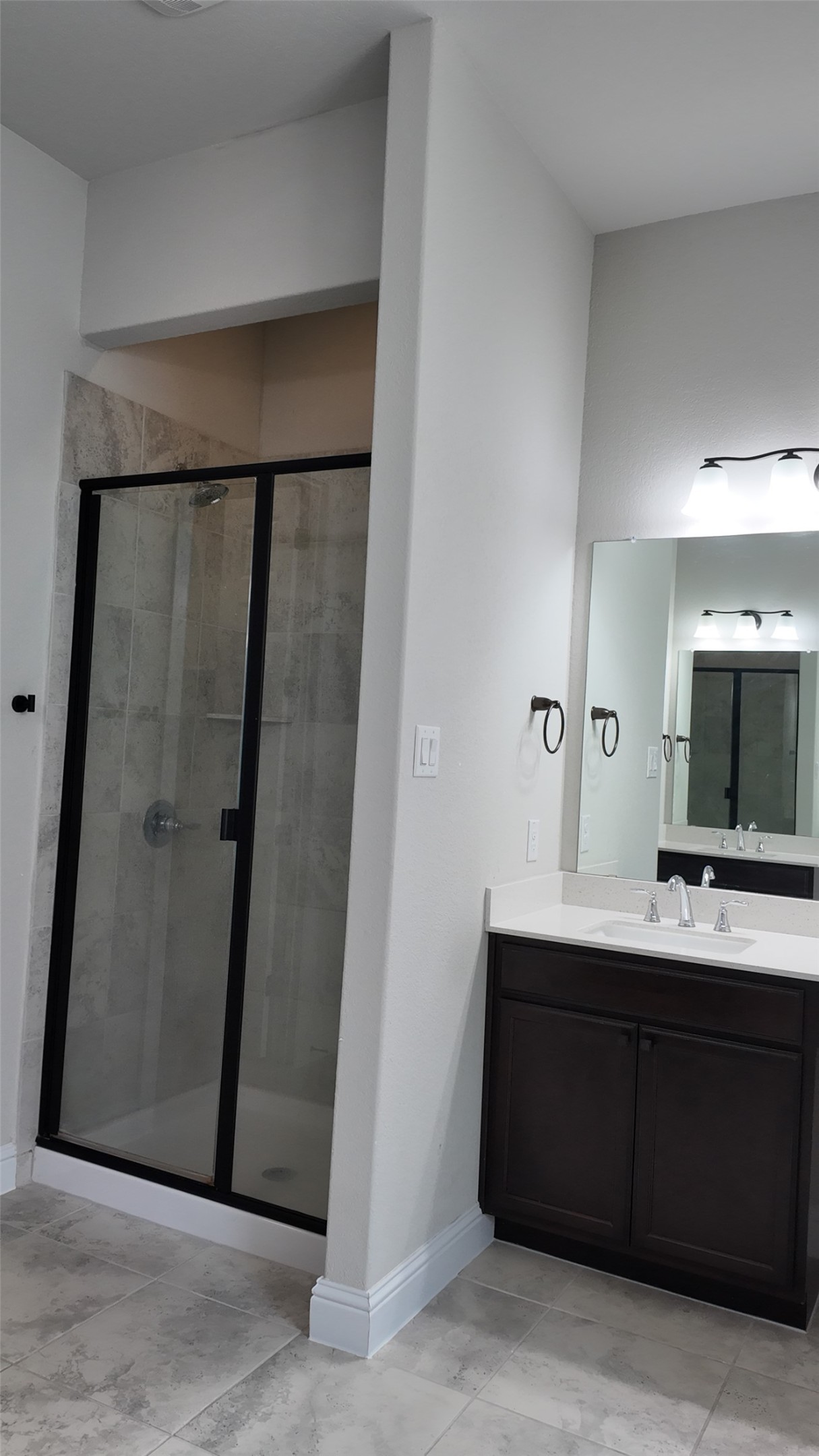 2320 Base Burner Path Leander, TX 78641 - Photo 19 of 24 A well-appointed bathroom features a glass-enclosed shower and a single vanity with ample storage.
