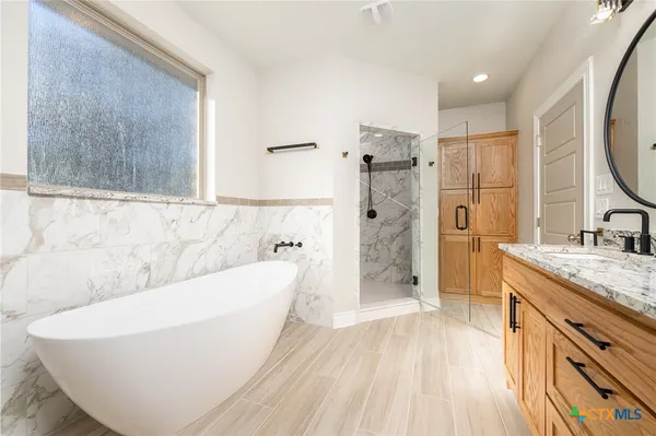 a bathroom with a bathtub and a sink
