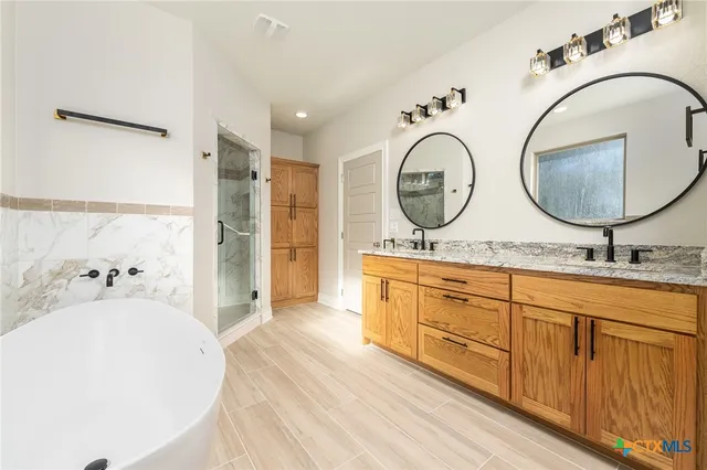 a bathroom with a double vanity sink and a mirror