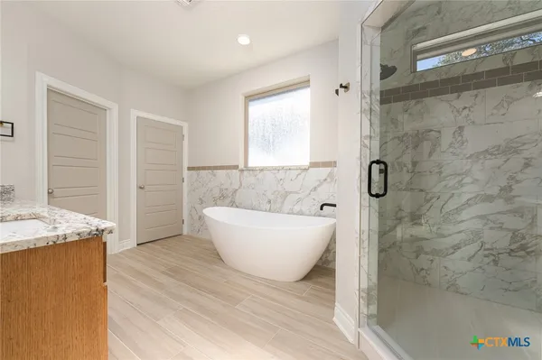 a view of bathroom with bathtub and shower