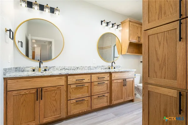 a bathroom with 2 sink and a mirror