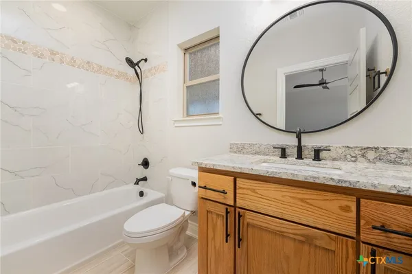 a bathroom with a toilet a sink and a mirror