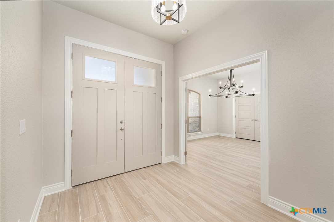 4249 Cold Springs Road Kempner, TX 76539 - Photo 5 of 48 an empty room with wooden floor and ceiling fan