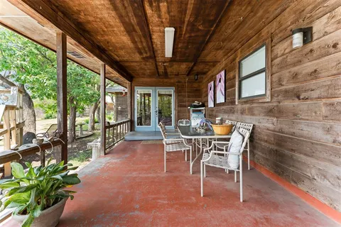 a dining room with furniture and a floor to ceiling window