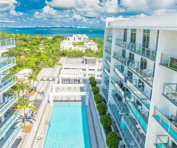 a room with painting on the wall and a potted plant