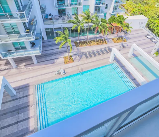 a balcony with furniture and a potted plant