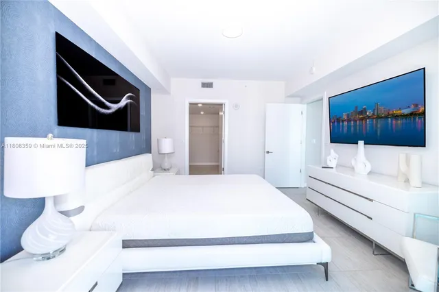 a bedroom with a bed and lamp