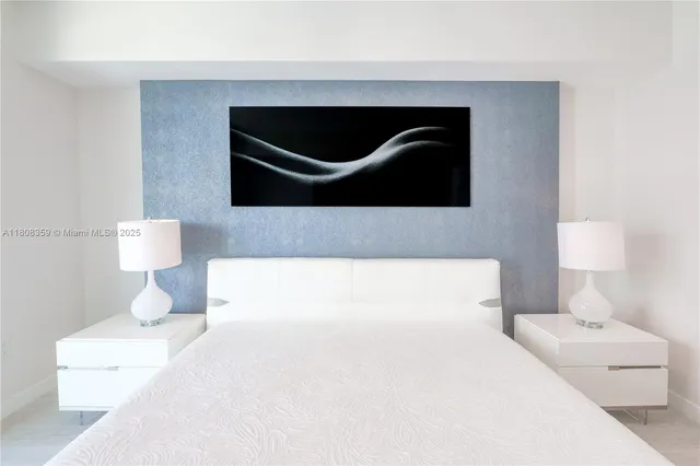 a spacious bedroom with a bed and glass window