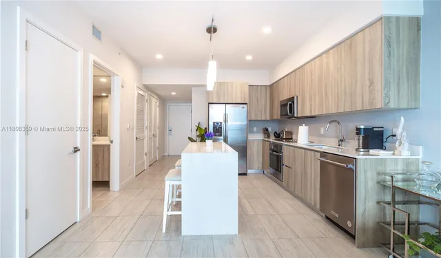 a kitchen with a sink cabinets and wooden floor