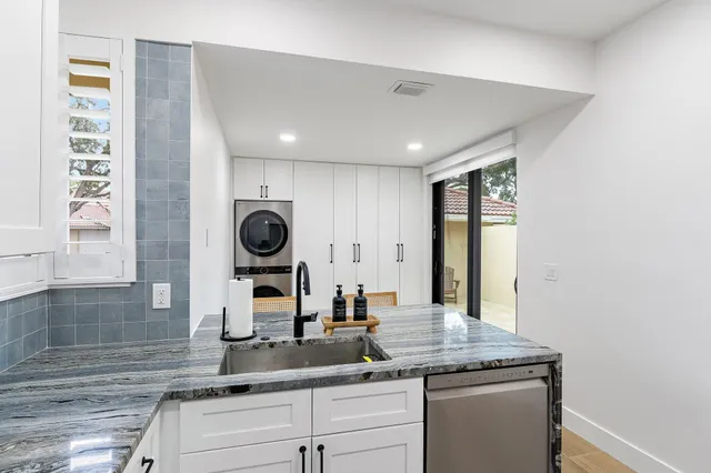 a kitchen with cabinets and window