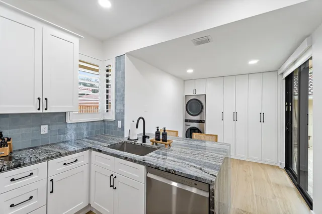 a kitchen with refrigerator cabinets and wooden floor