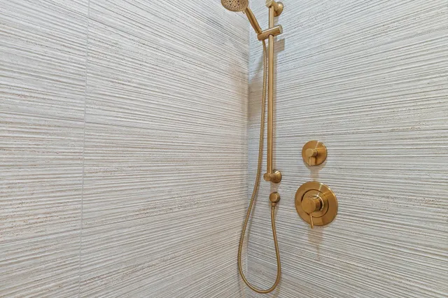 a bedroom with a bed and lamp with the large window