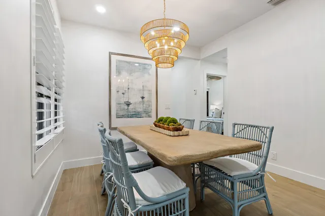 a view of a dining room with furniture and chandelier