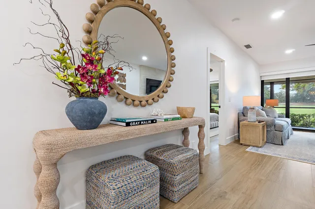 a living room with furniture flowerpot and a chandelier
