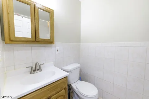 a bathroom with a sink a toilet and mirror