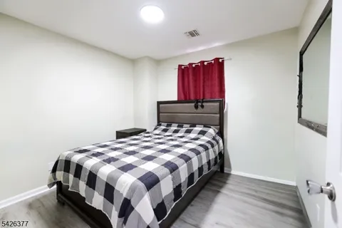 a room with a bed and a flat screen tv