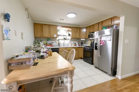 a kitchen with a sink a refrigerator and cabinets