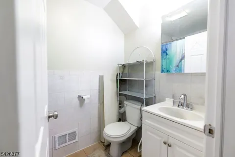 a bathroom with a sink toilet and a mirror