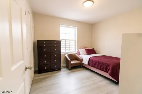 a bedroom with a bed and a chair