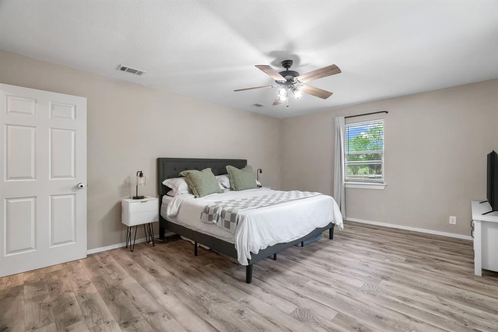 360 County Road 4358 Decatur, TX 76234 - Photo 17 of 38 Bedroom featuring wood finished floors, a ceiling fan, and baseboards
