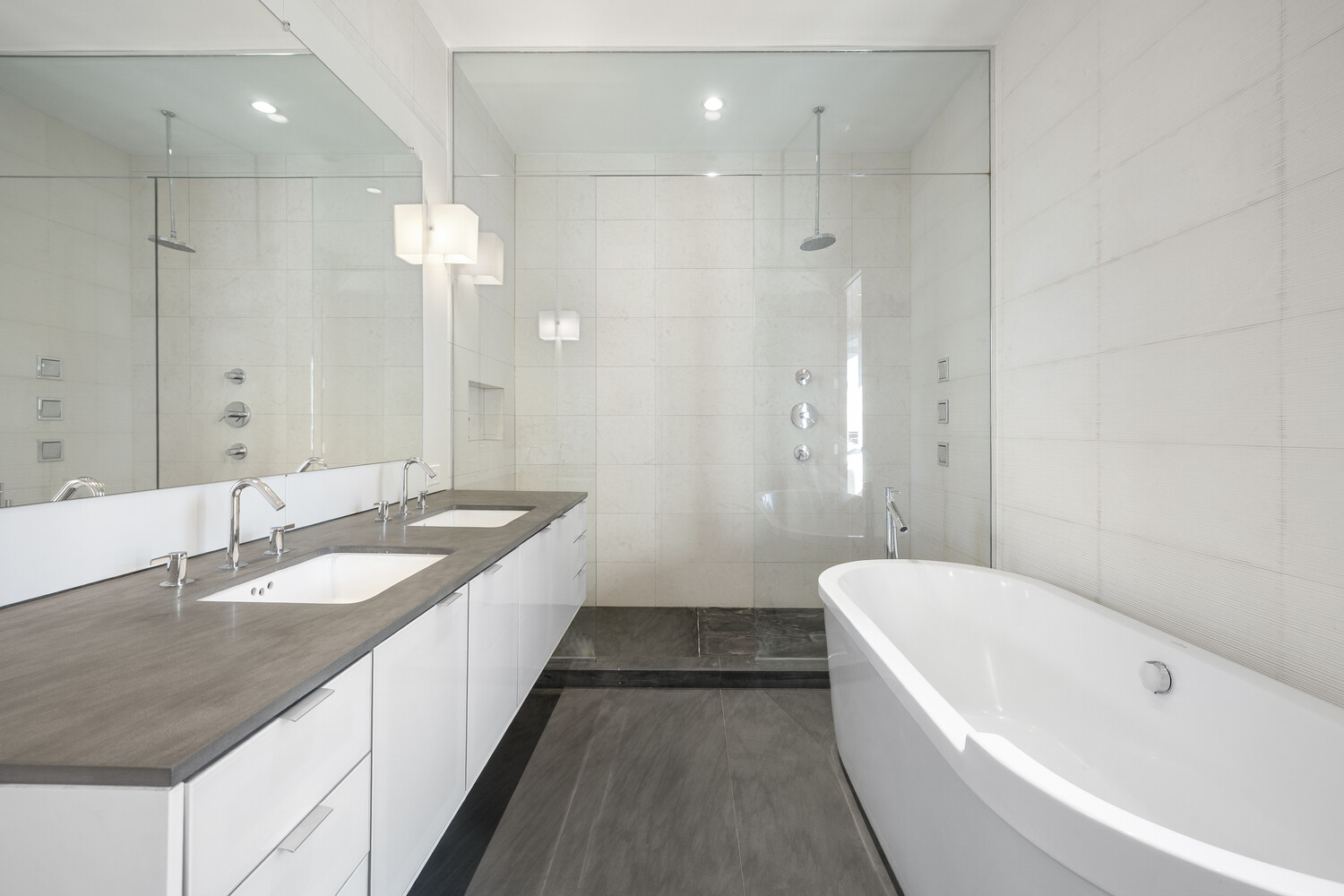 85 Leonard Street, Unit PH Manhattan, NY 10013 - Photo 17 of 21 a bathroom with a granite countertop double vanity sink large mirror and a bathtub