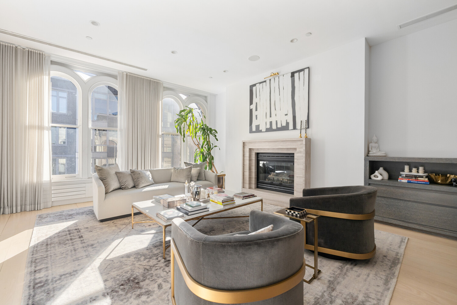 85 Leonard Street, Unit PH Manhattan, NY 10013 - Photo 2 of 21 a living room with furniture and a fireplace