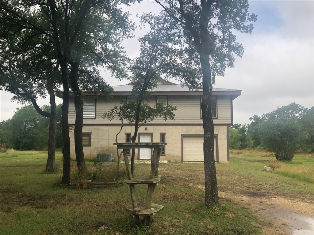 317 The Ranch Road Del Valle, TX 78617 - Photo 1 of 1 a backyard of a house with table and chairs