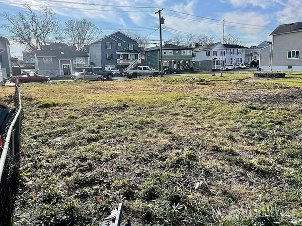 a view of residential houses with yard