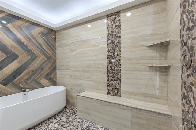 a bathroom with a bathtub and shower