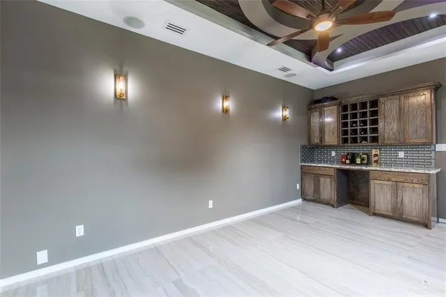 a kitchen with stainless steel appliances kitchen island granite countertop a stove a sink and a refrigerator