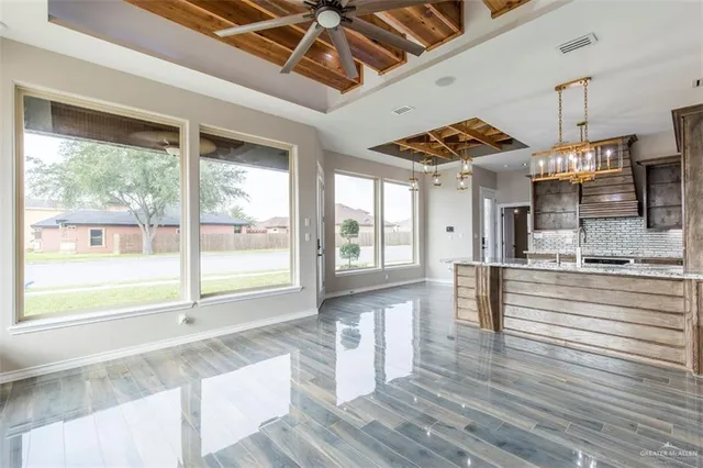 a view of large living room with wooden floor and windows
