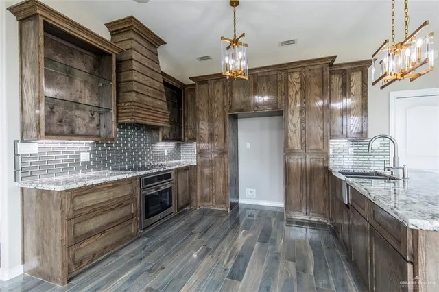a kitchen with granite countertop a stove and a refrigerator