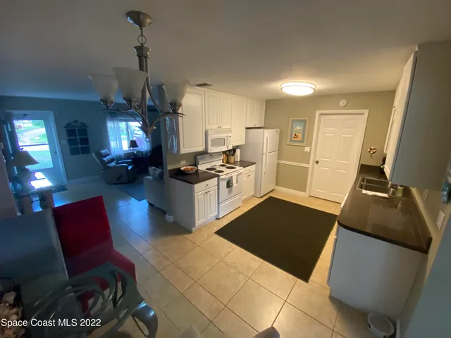 a kitchen with stainless steel appliances kitchen island granite countertop a refrigerator and a stove