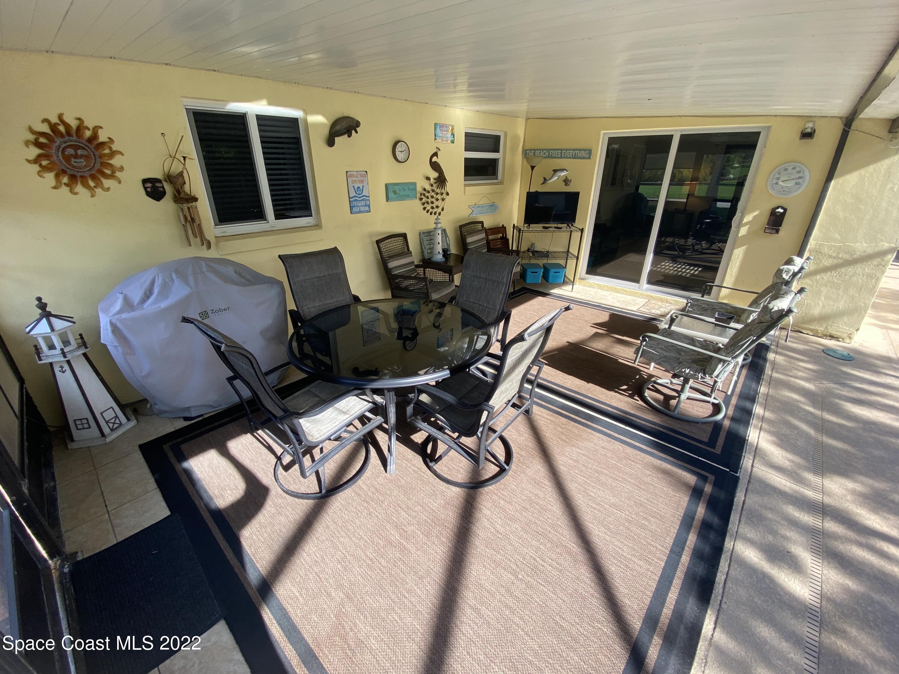 8800 Sea Shell Lane Cape Canaveral, FL 32920 - Photo 17 of 22 a living room with furniture and a flat screen tv