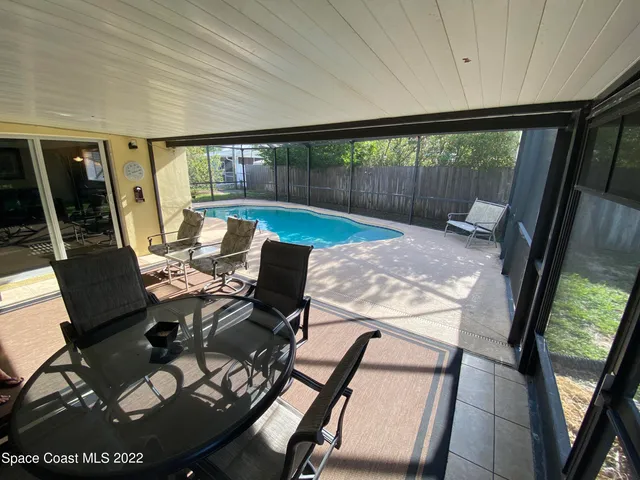 a view of a porch with furniture and wooden floor