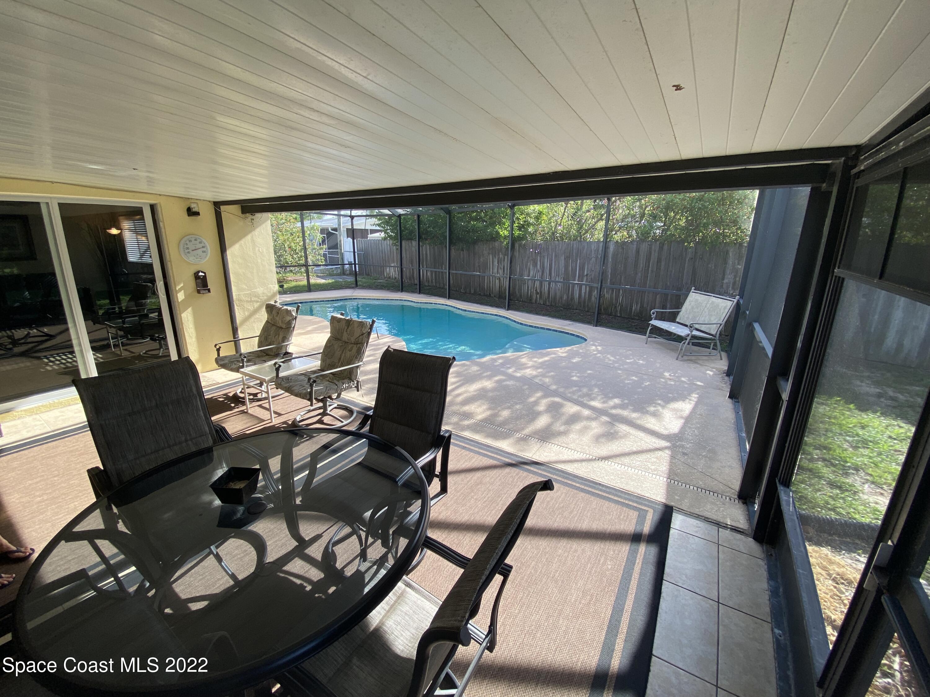 8800 Sea Shell Lane Cape Canaveral, FL 32920 - Photo 19 of 22 a view of a porch with furniture and wooden floor
