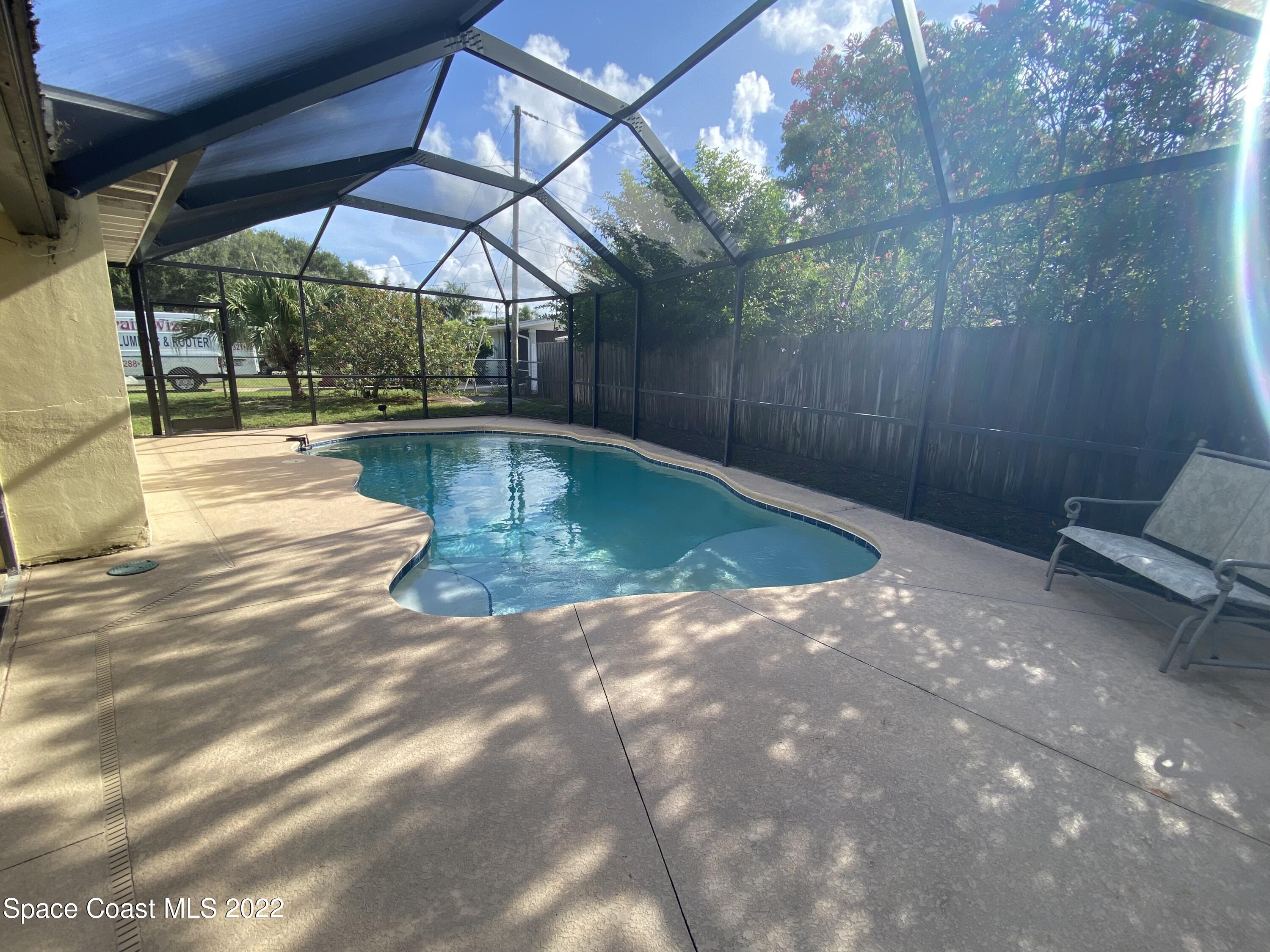 8800 Sea Shell Lane Cape Canaveral, FL 32920 - Photo 20 of 22 a view of a backyard with swimming pool