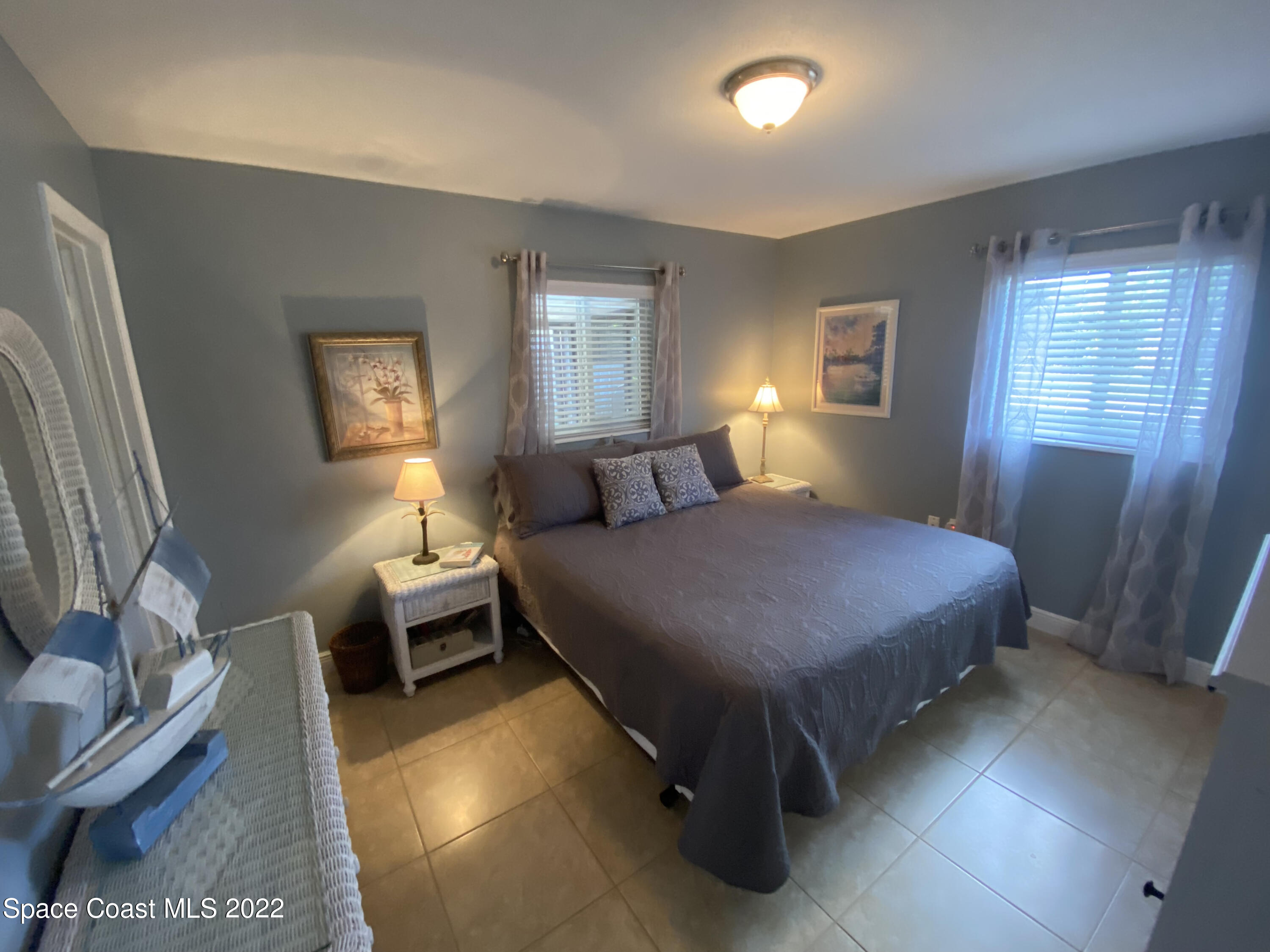 8800 Sea Shell Lane Cape Canaveral, FL 32920 - Photo 2 of 22 a bedroom with a bed and window