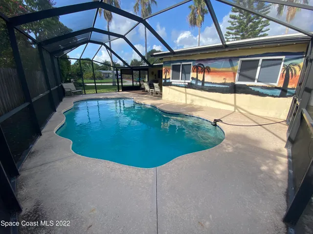 a view of a swimming pool with a yard