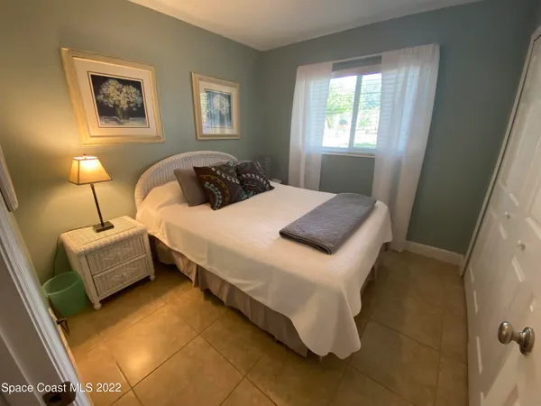 a bedroom with bed and window