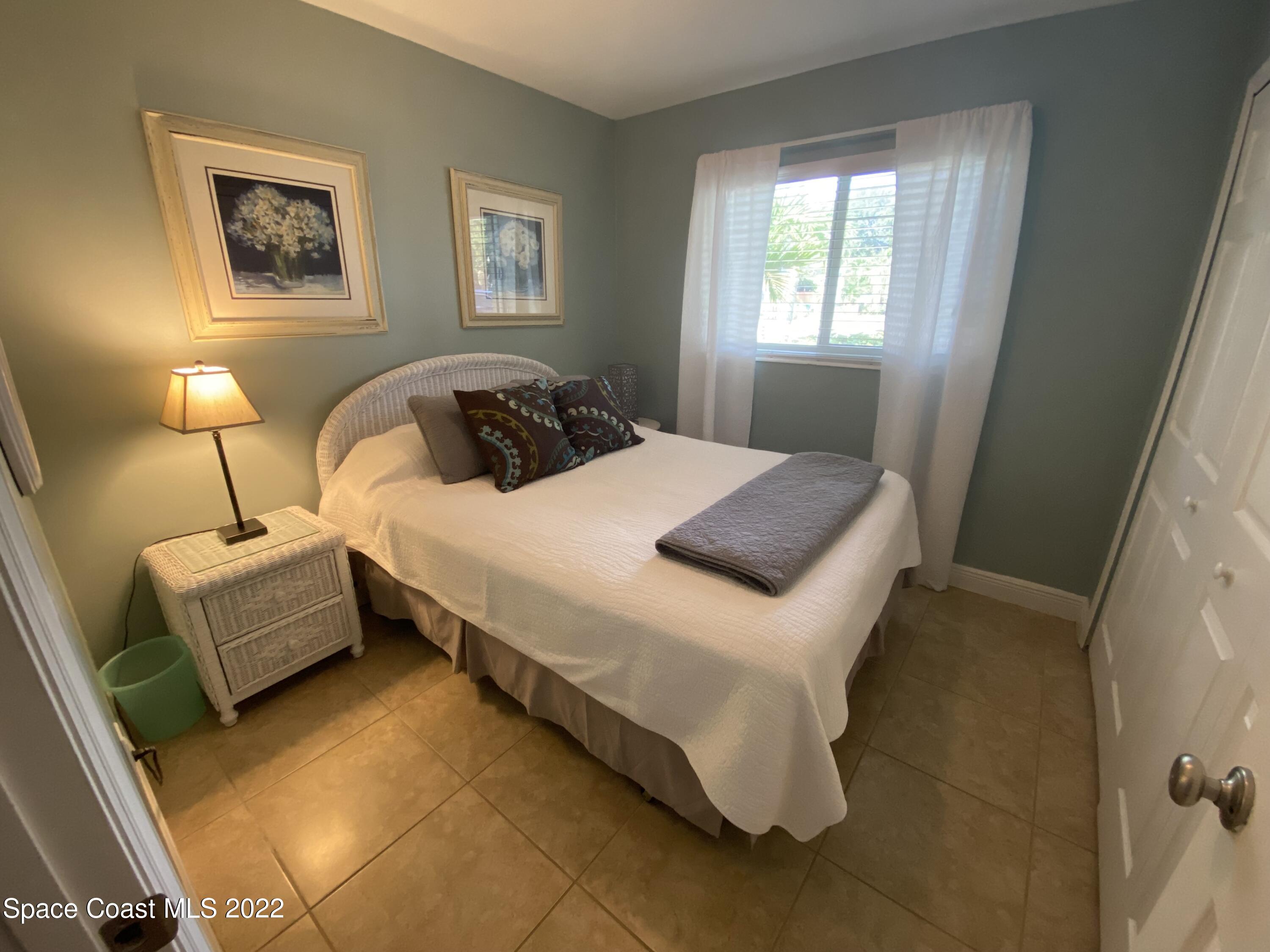 8800 Sea Shell Lane Cape Canaveral, FL 32920 - Photo 4 of 22 a bedroom with bed and window