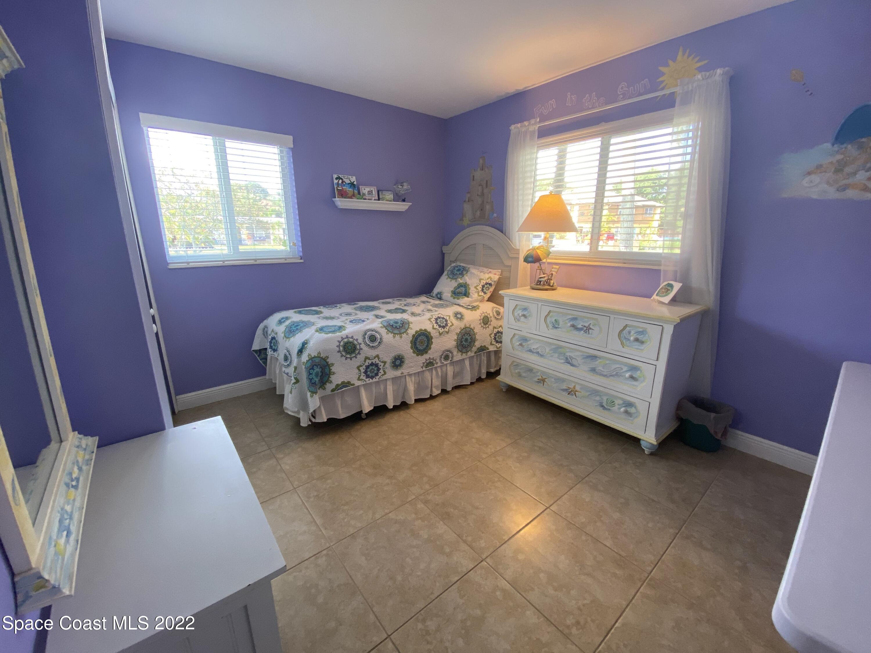 8800 Sea Shell Lane Cape Canaveral, FL 32920 - Photo 5 of 22 a bedroom with a bed and a window
