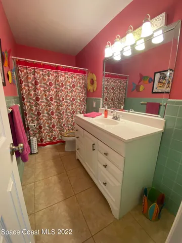 a bathroom with a sink mirror vanity and toilet