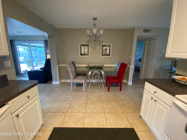 a living room with furniture a flat screen tv and windows