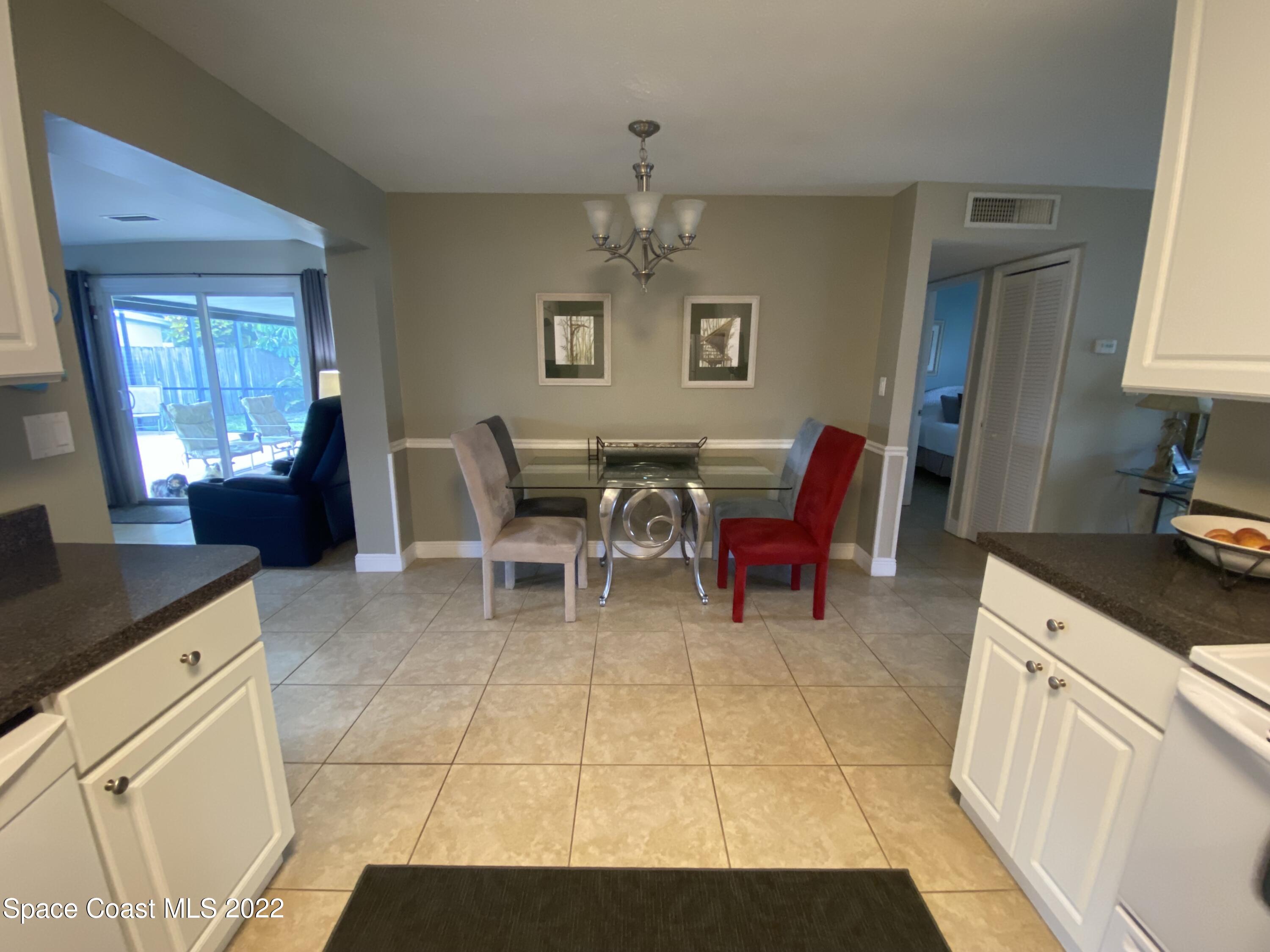 8800 Sea Shell Lane Cape Canaveral, FL 32920 - Photo 10 of 22 a living room with furniture a flat screen tv and windows