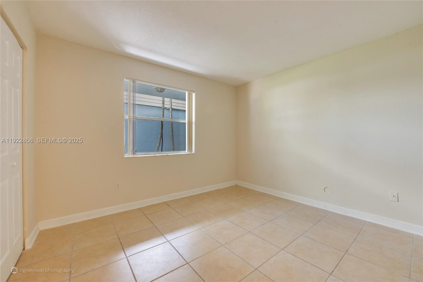 4600 Southwest 67th Avenue, Unit 125 Miami, FL 33155 - Photo 5 of 11 an empty room with a window