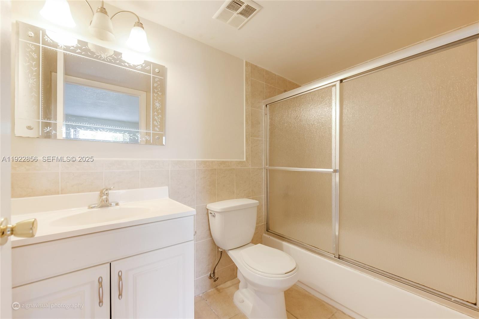 4600 Southwest 67th Avenue, Unit 125 Miami, FL 33155 - Photo 9 of 11 a bathroom with a sink a toilet and shower